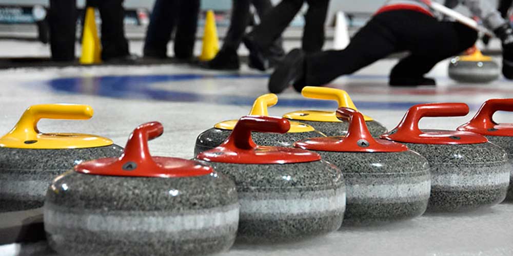 More curling stones on ice